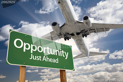 Image of Opportunity Green Road Sign and Airplane Above