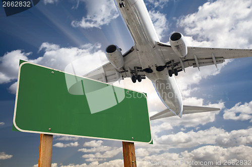 Image of Blank Green Road Sign and Airplane Above