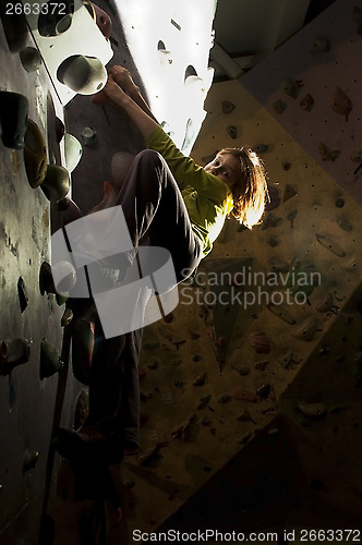 Image of child rock climbing up the wall