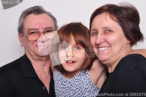 Image of portrait of a grandchild with grandparents