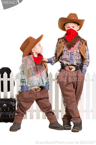 Image of Two boys posing in cowboy costumes