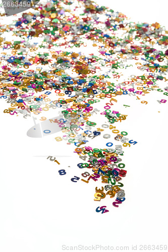 Image of small color numbers confetti on white