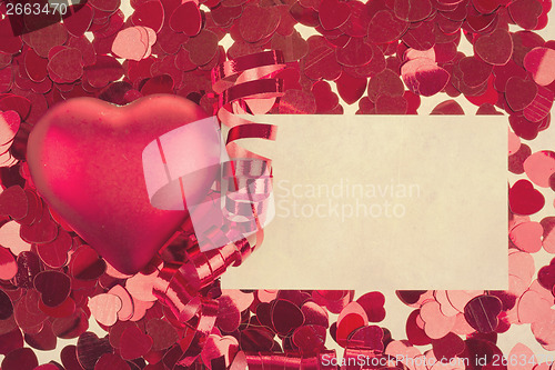 Image of small red confetti and big hearts in retro color