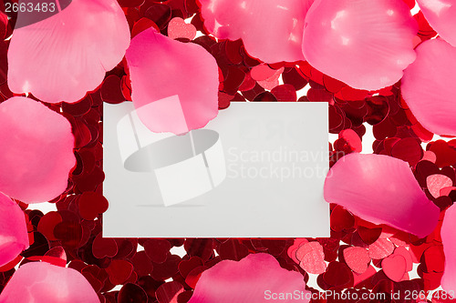 Image of small red confetti and big hearts on white background