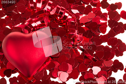 Image of small red confetti and big hearts on white background