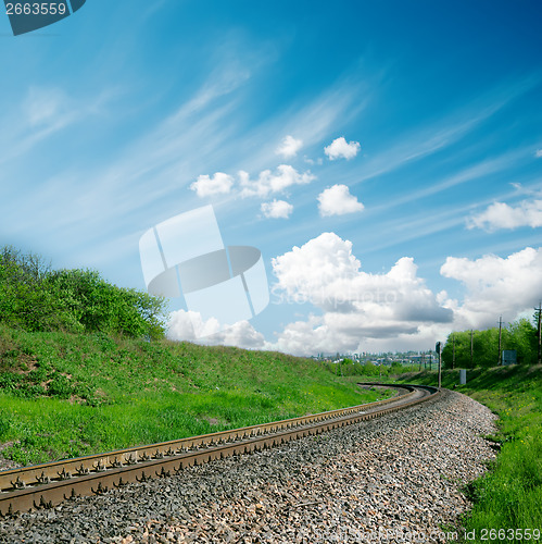 Image of railroad to horizon and cloudy sky