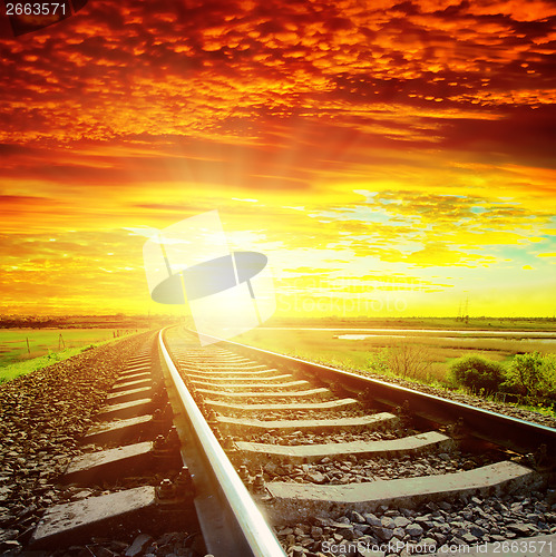 Image of sunset with red clouds and railroad to horizon