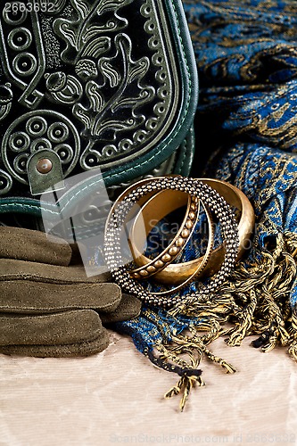 Image of vintage bag, leather gloves, bracelets and scarf