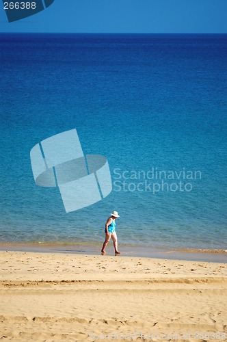 Image of woman walking in beach