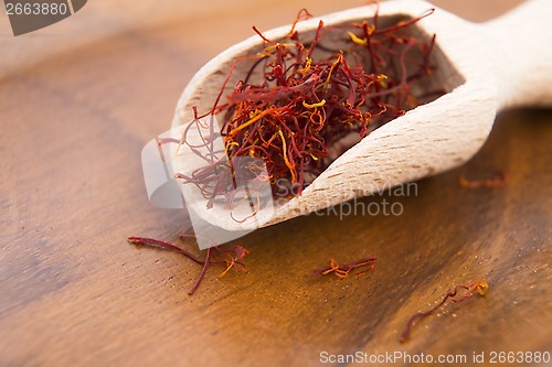 Image of stigmas of saffron in wooden spoon