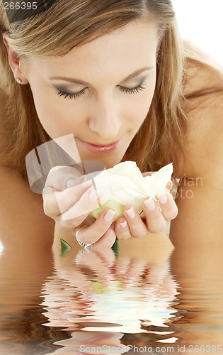Image of happy girl with white rose in water