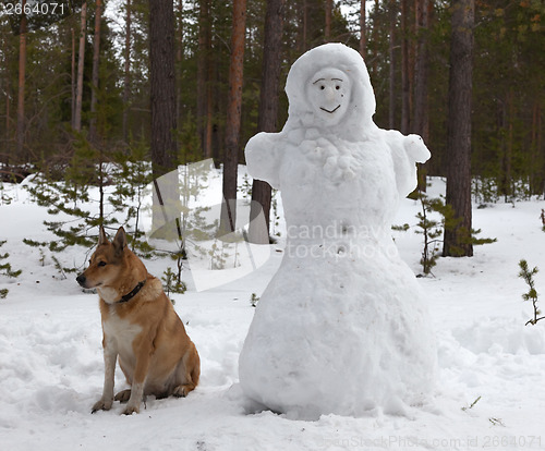 Image of Sculpture of a woman made of snow in the forest park 