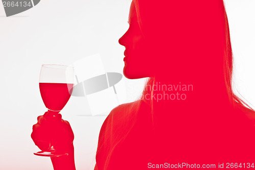 Image of Scandinavian cute young girl drinking wine