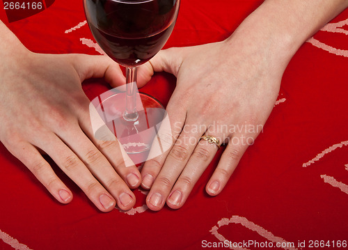 Image of Scandinavian cute young girl hands shaping a heart and wine glas