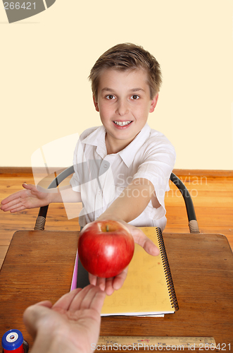 Image of Student giving teacher an apple
