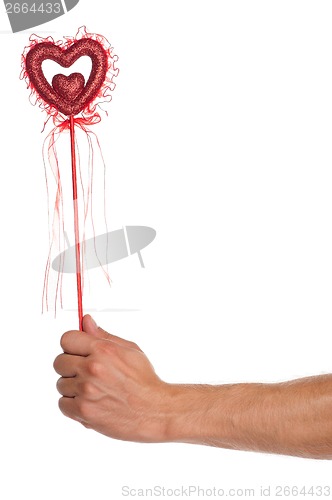 Image of Hand with heart on a stick