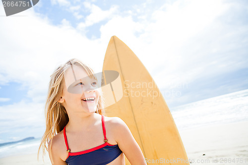 Image of Happy young girl with surfboard at beach