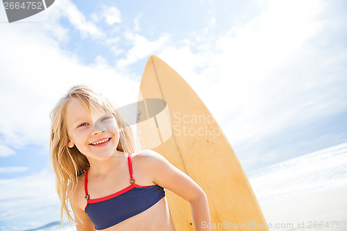 Image of Happy young girl with surfboard at beach