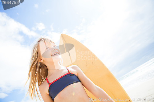 Image of Happy young girl with surfboard at beach