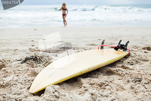 Image of Surfboard in sand on beach