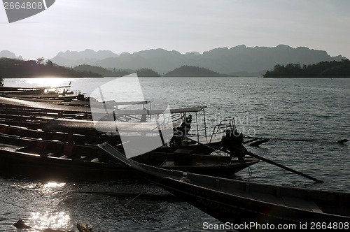 Image of Long tail boats on a lake . Chiew Lan Lake (Rajjaphapa Dam), Tha