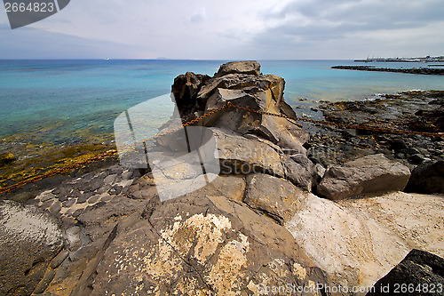 Image of pier rusty chain  water  boat   and summer lanzarote spain