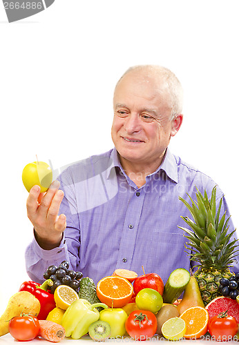 Image of senior man holding a green apple