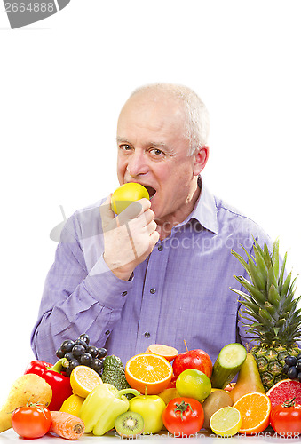 Image of senior man eating a green apple