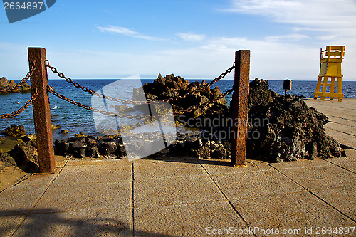 Image of yellow lifeguard chair cabin  in spain  lanzarote  rock stoner  