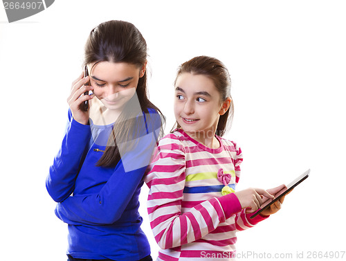 Image of Happy teen girls with digital tablet and smartphone 