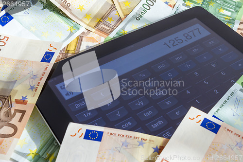 Image of Calculating money on tablet computer