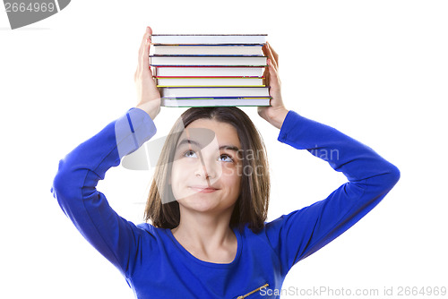 Image of Young girl with stack of books on her head 