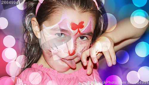 Image of A YOUNG GIRL WITH HER FACE PAINTED