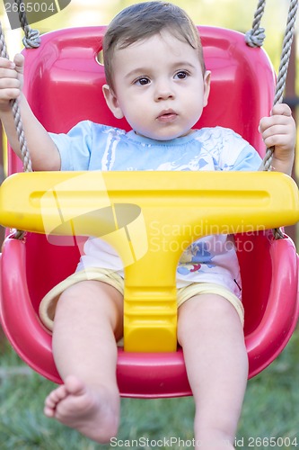 Image of baby boy in swing