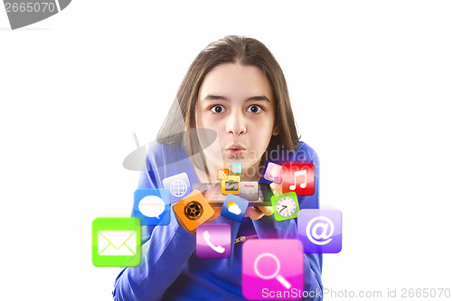 Image of Teenage girl blowing app icons from digital tablet