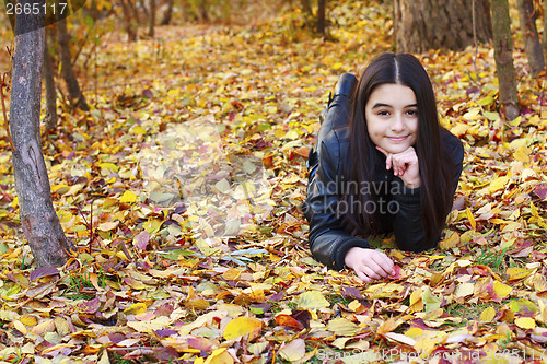 Image of Teenager laying on leaves