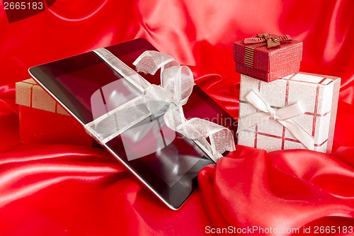 Image of Digital tablet with christmas present