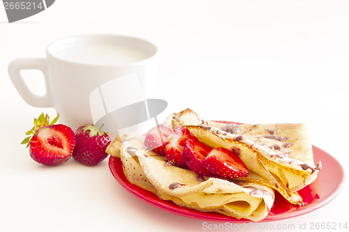 Image of sweet pancakes with strawberry and cup of milk