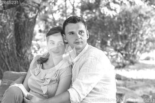 Image of Young couple relaxing in park