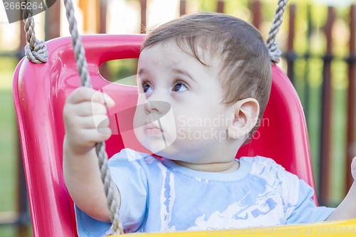 Image of baby boy in swing