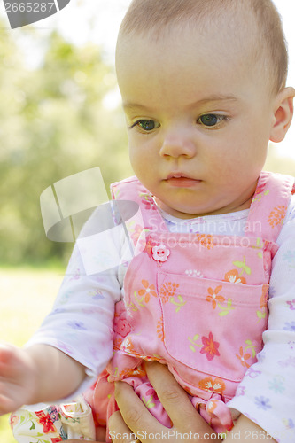 Image of Thinking baby girl looking down