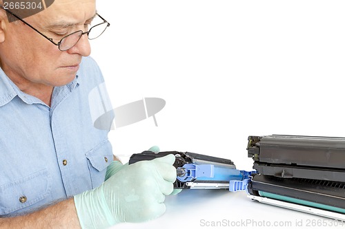 Image of Man repairing toner cartridge