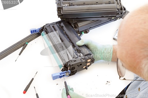 Image of adult man working toner cartridge