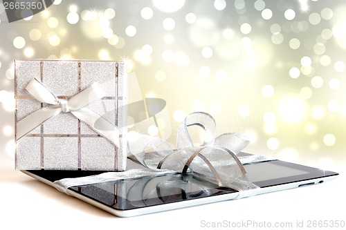 Image of Digital tablet with christmas present