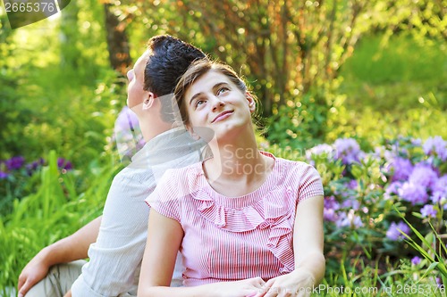 Image of Young couple relaxing in park