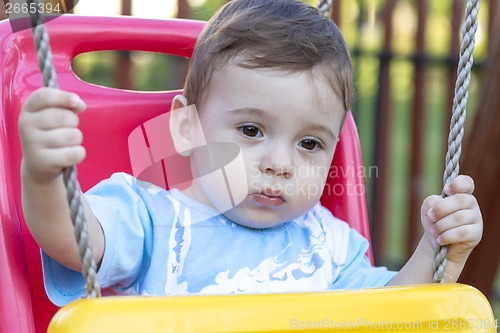 Image of baby boy in swing