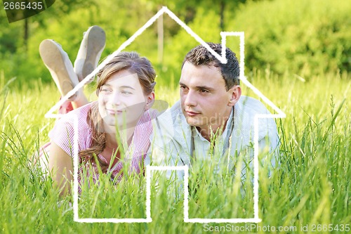 Image of Young couple dreaming to a house