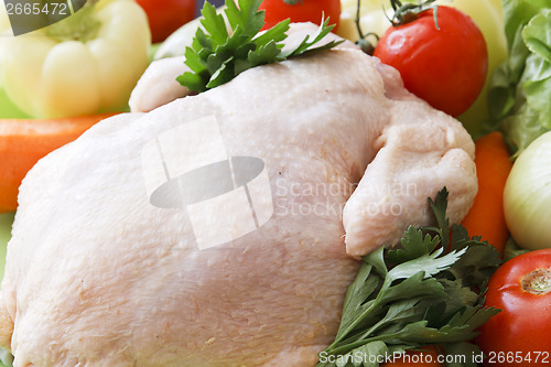 Image of whole raw chicken with vegetables