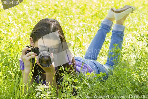 Image of Young girl taking photos 