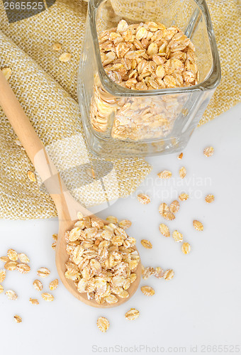 Image of Oat-flakes with a wooden spoon